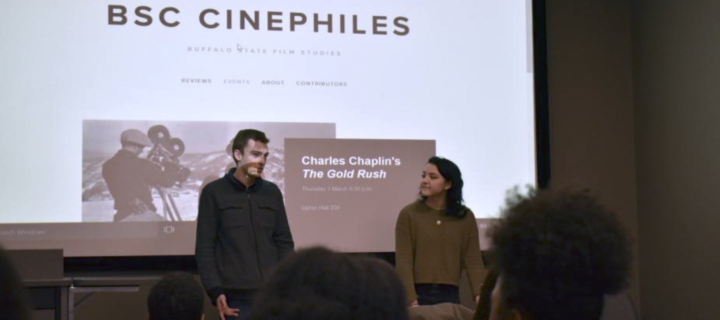 Cinephile students in front of a screen